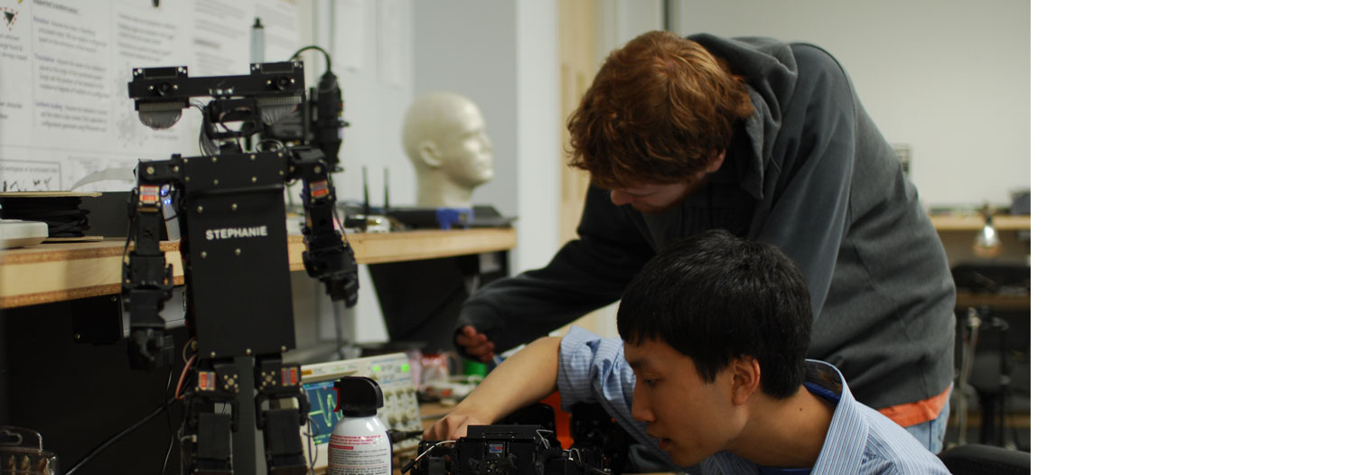 Slide Image: Members of the Applied Robotics Club working together.